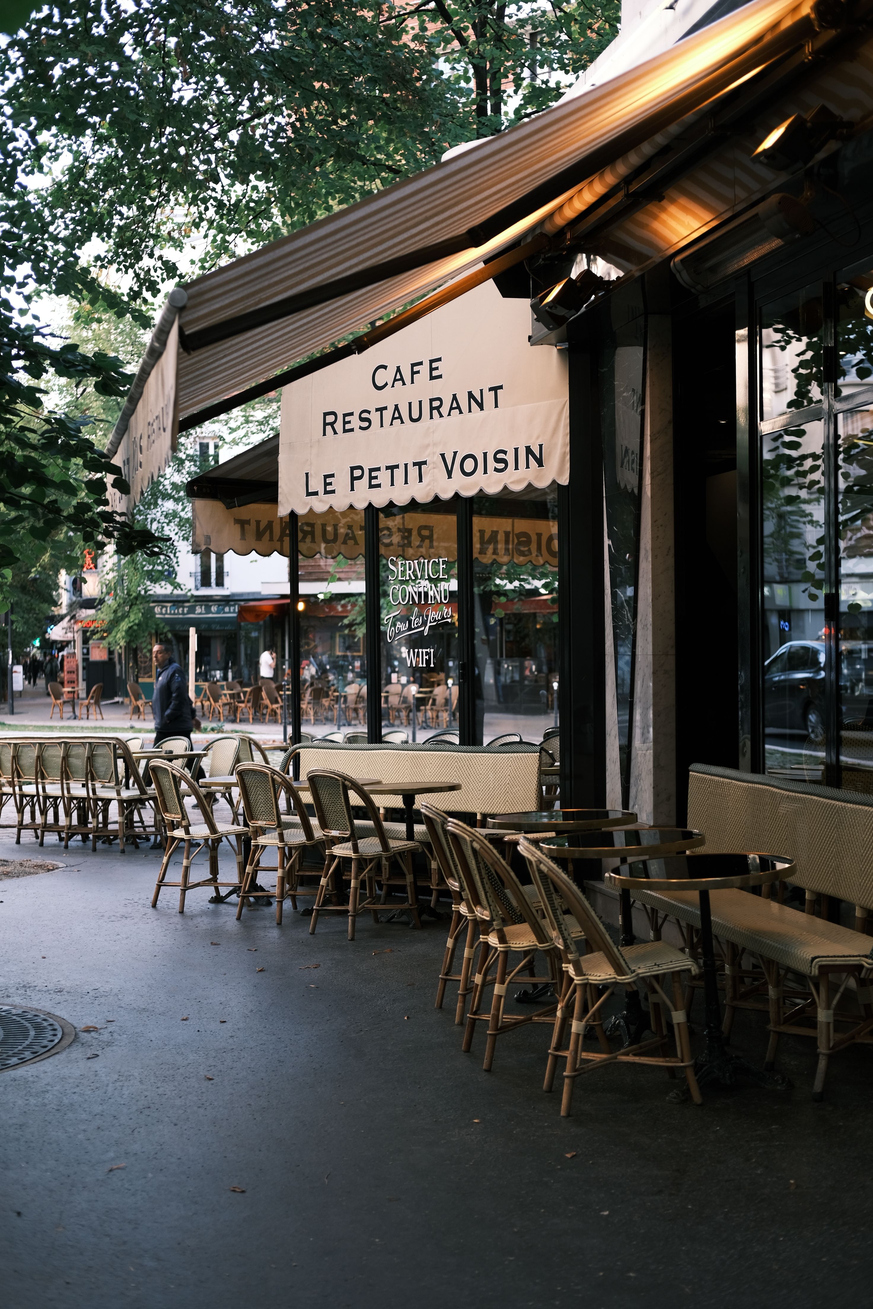 Person using a phone at a Parisian café