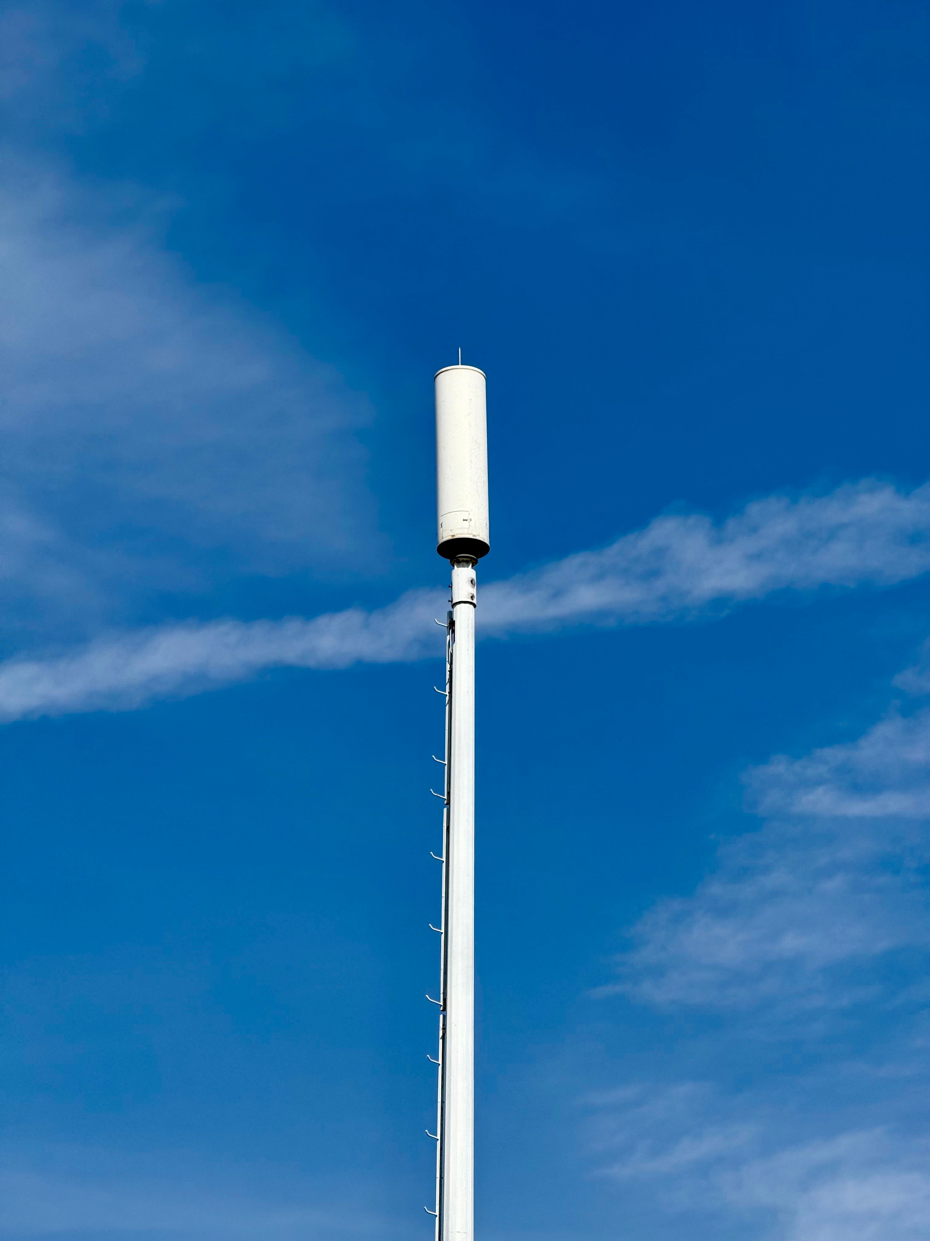 A mobile phone mast against a clear blue sky