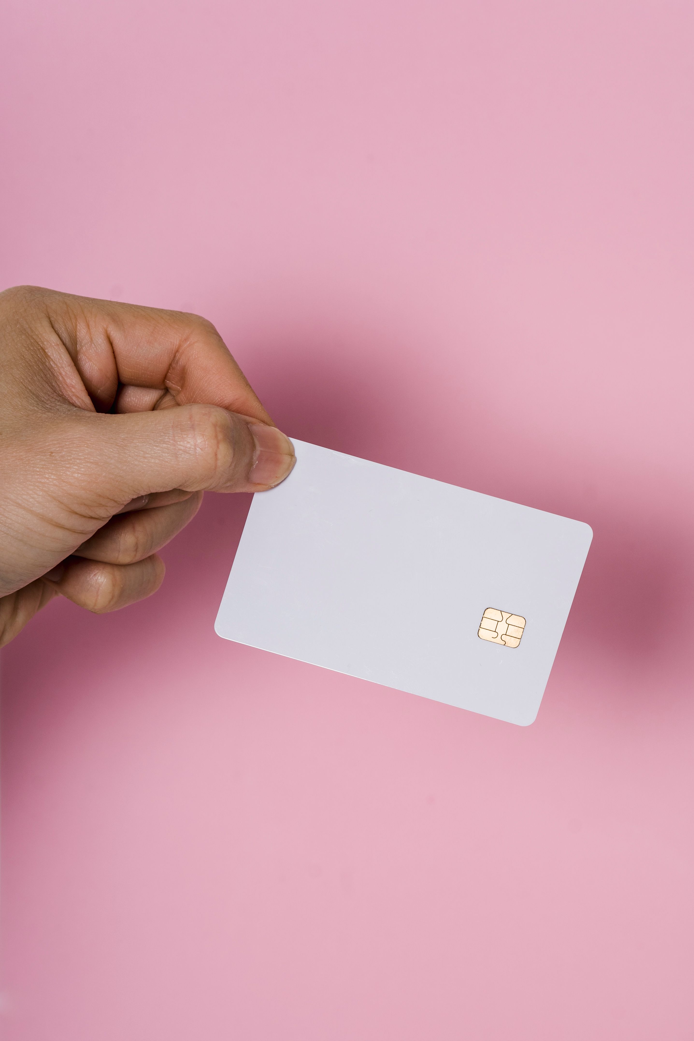 A hand holding a SIM card