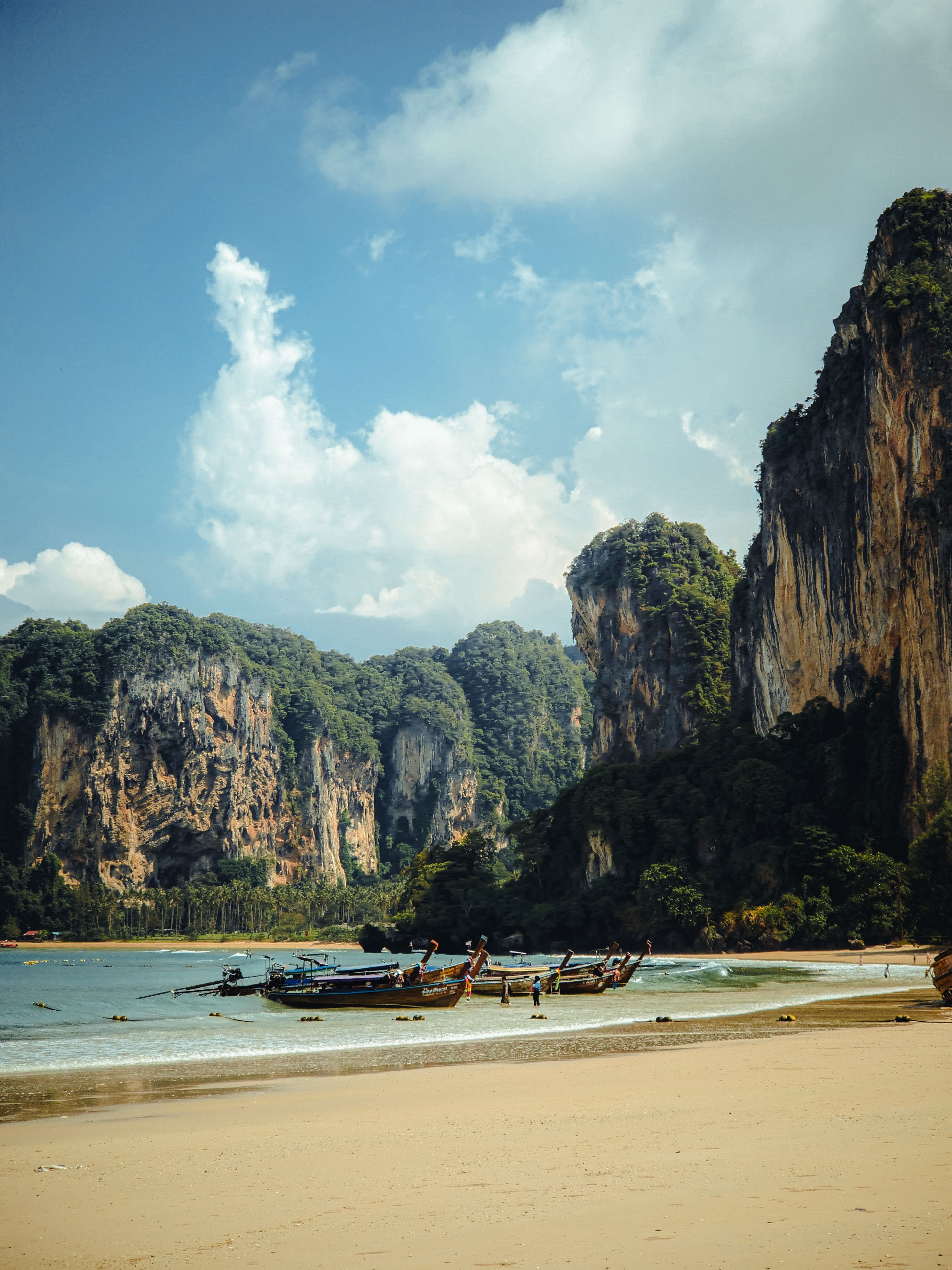 Limestone cliffs and longtail boats in Krabi, Thailand