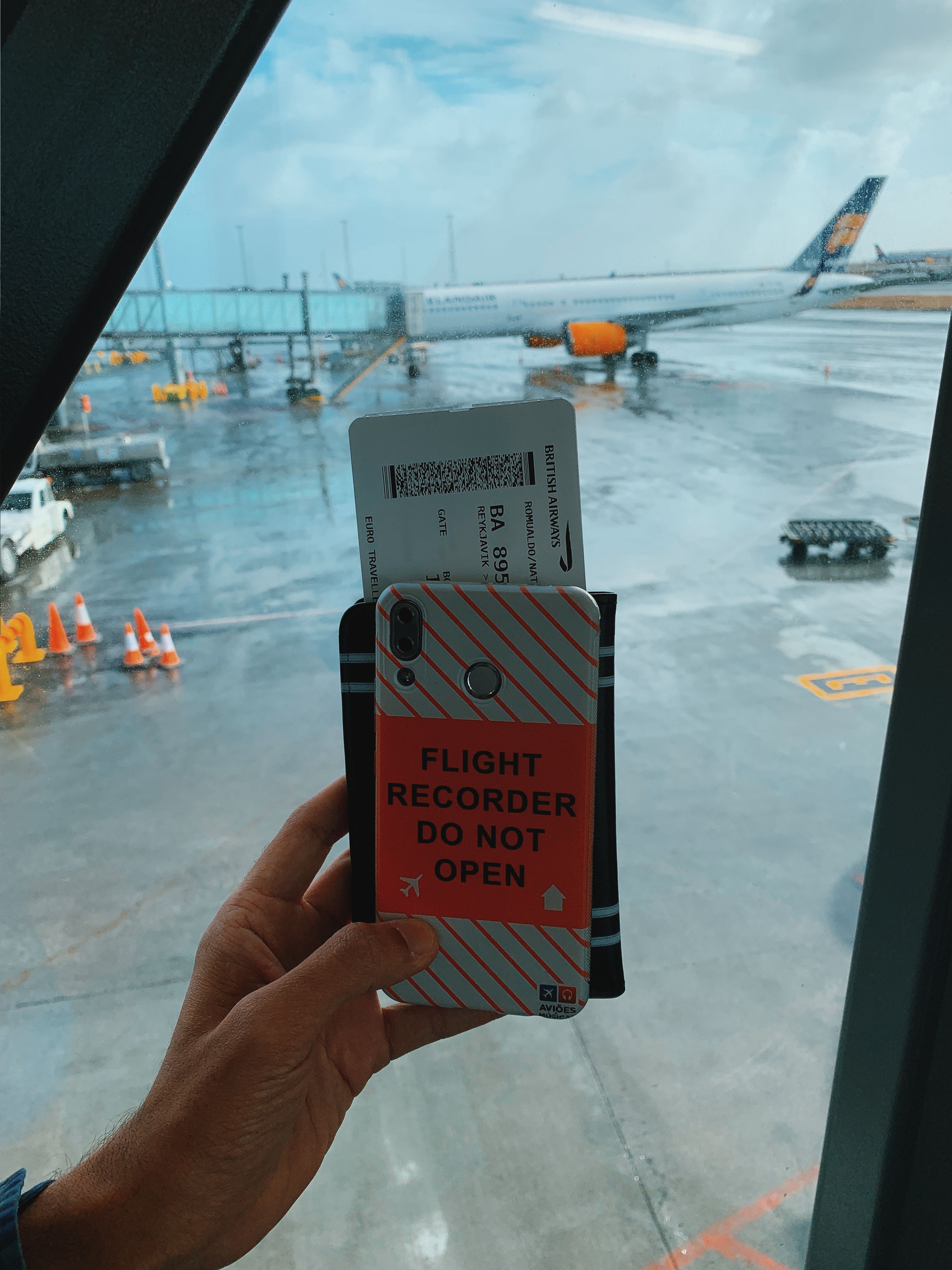 Traveller checking their phone at the airport before a flight