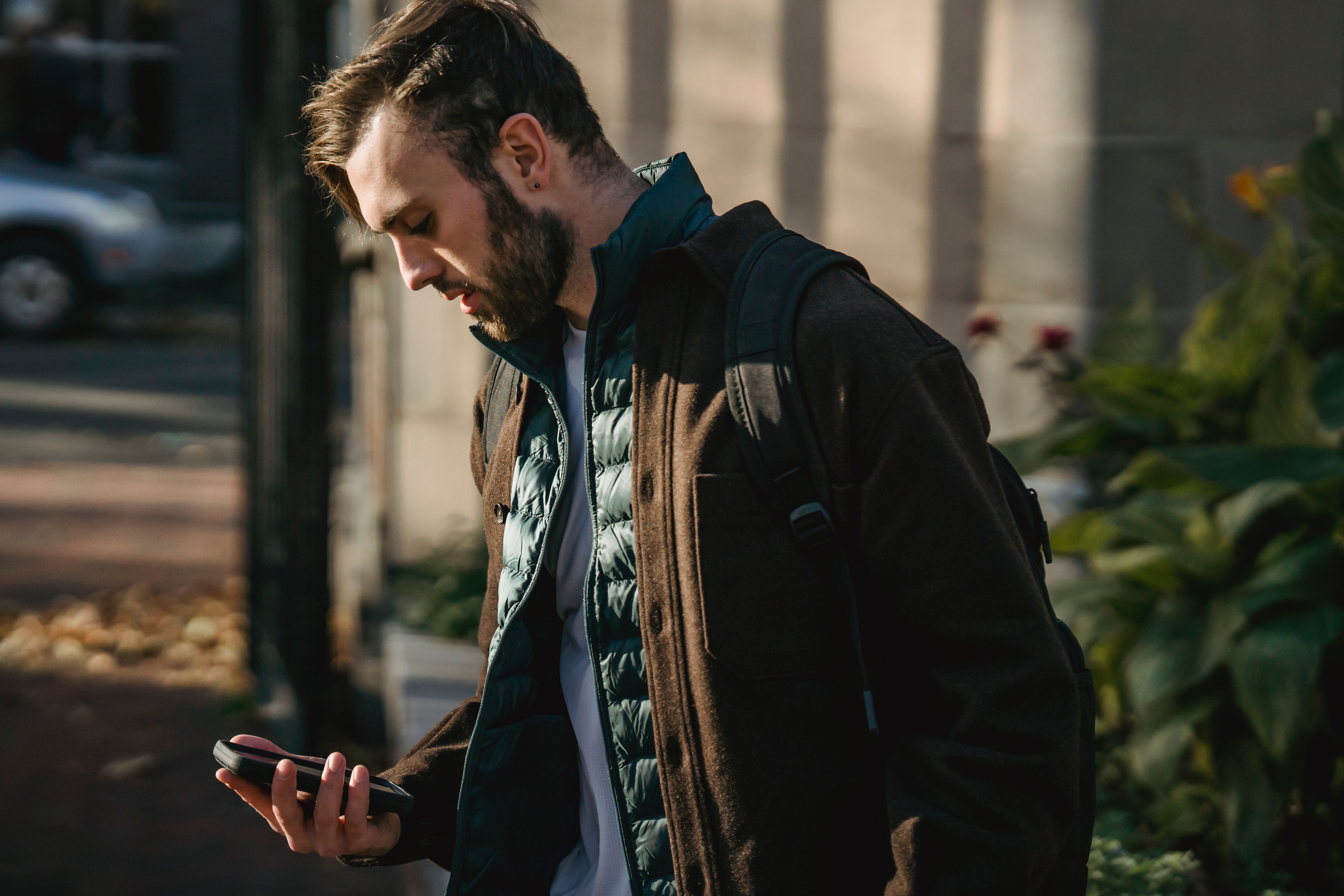 A traveller checking their phone on a city street