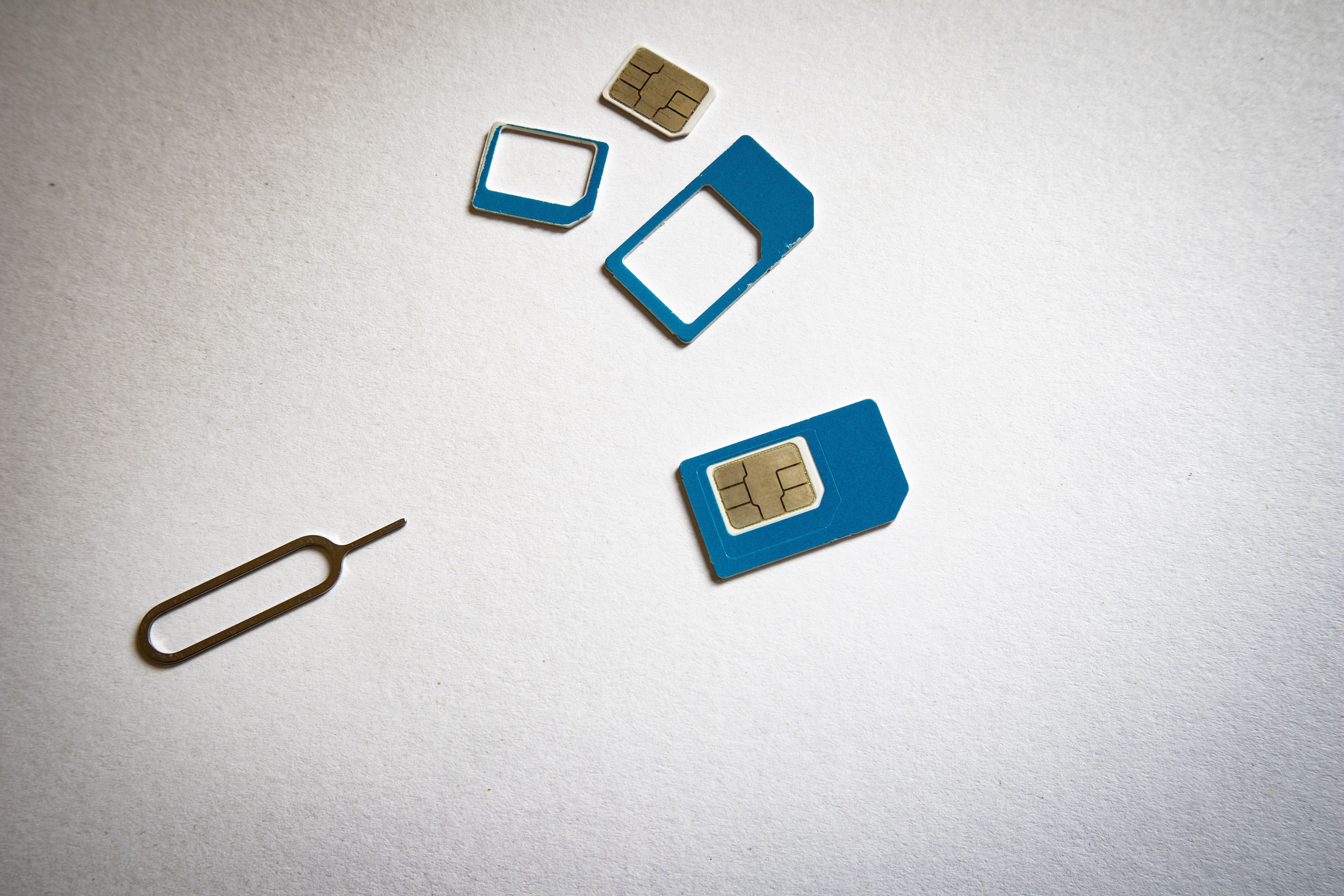Close-up of a SIM card and ejector tool